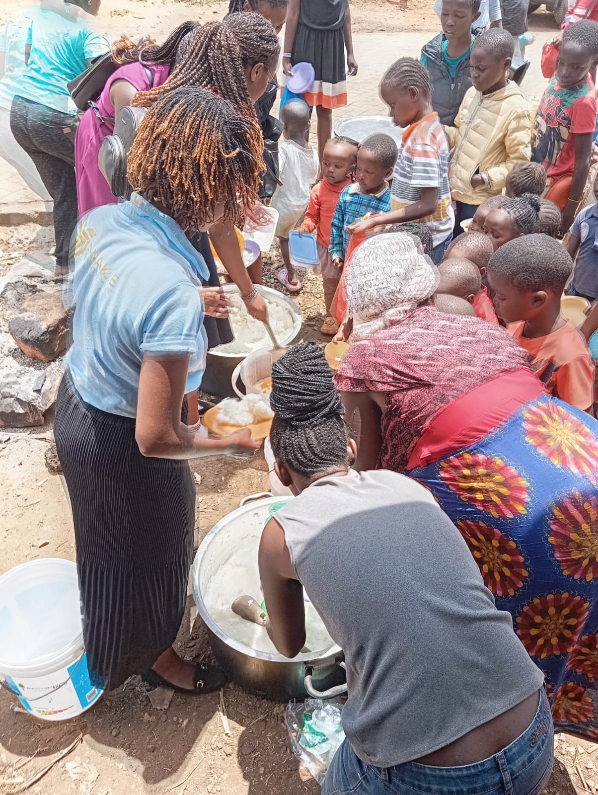 Volunteers serving food to children